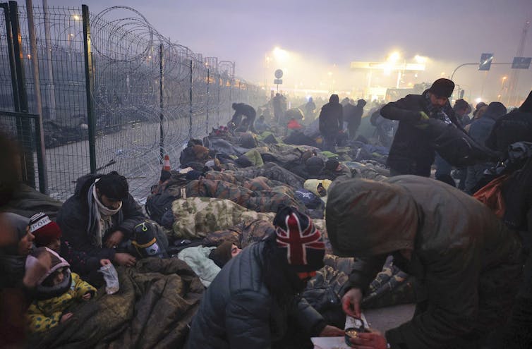 Migrants gathered at a checkpoint at the Belarus-Poland border.