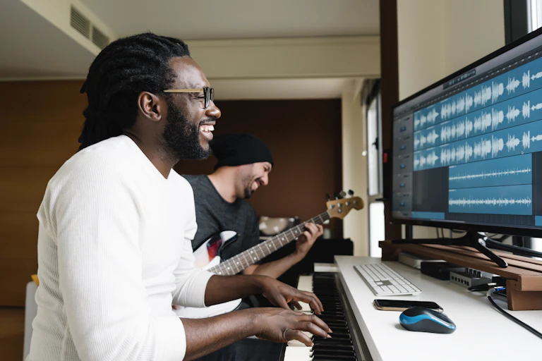 Pair of musicians recording music at home