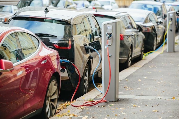Electric vehicles charging on the street