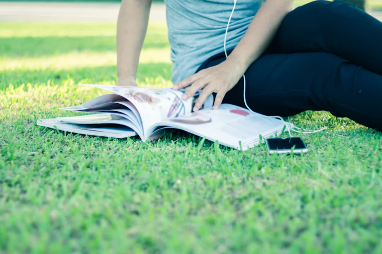 Woman reading a magazine on a lawn