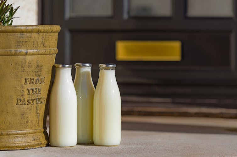 Botellas de leche en la puerta.