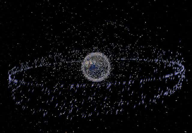 Artist's view of traceable debris around the Earth - the debris is shown magnified relative to the size of the Earth.