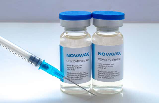 Two vials of Novavax COVID vaccine and a syringe