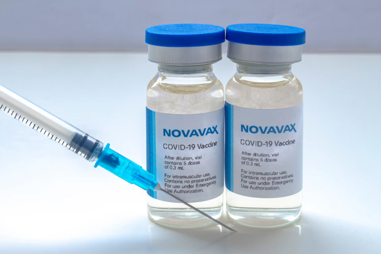 Two vials of Novavax COVID vaccine and a syringe