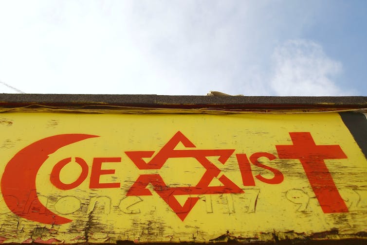 View of a religious tolerance themed graffiti piece by an unidentified artist on a city centre building.