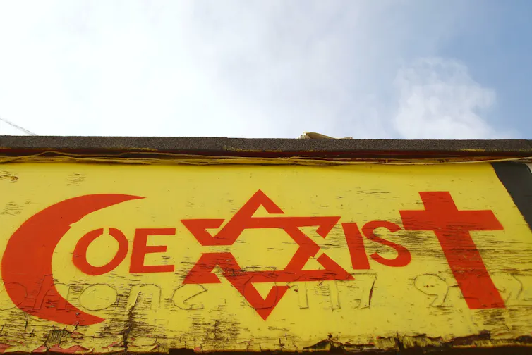 View of a religious tolerance themed graffiti piece by an unidentified artist on a city centre building.