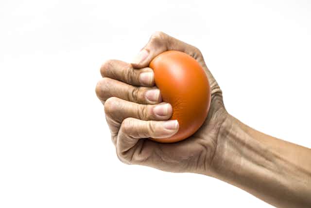 Hand clutching a stress ball.