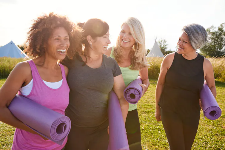 Four women with yoga mats