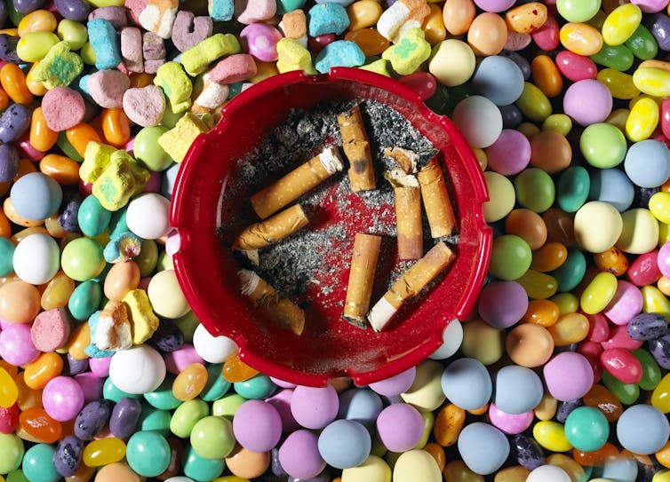 cigarettes in ashtray atop candy