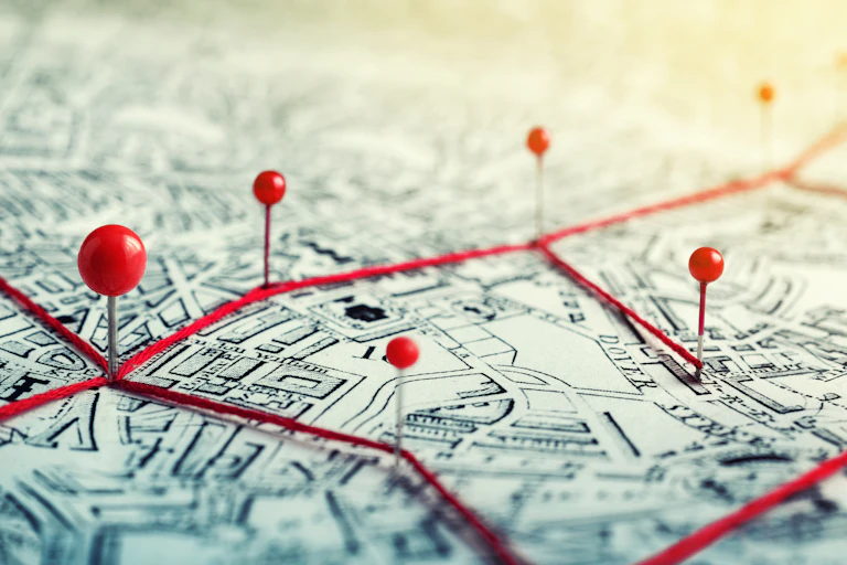 Red pins on a map of a city.