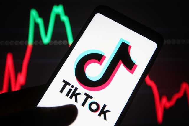 A phone displaying the TikTok logo.