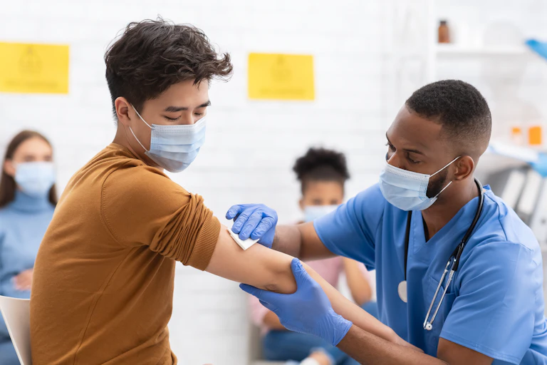 Man being vaccinated by a doctor