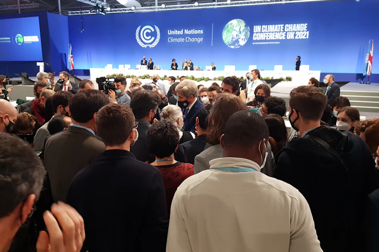 US climate negotiator John Kerry at the centre of a huddle of delegates at the COP26 climate summit in Glasgow.