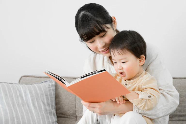 Mother and child look at book