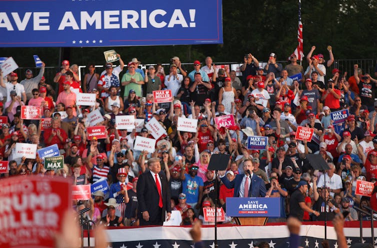 Donald Trump at a rally in front of a lot of people.