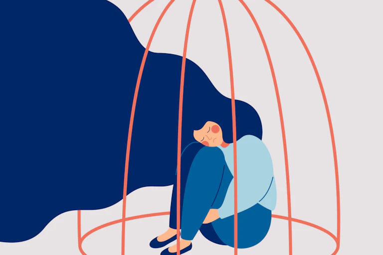 Woman in a cage looking sad