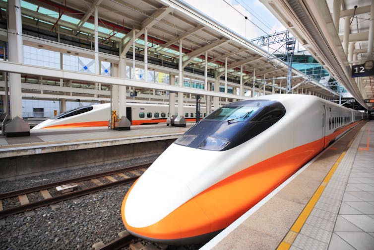 High speed bullet train at the platform in a Japanese railway station