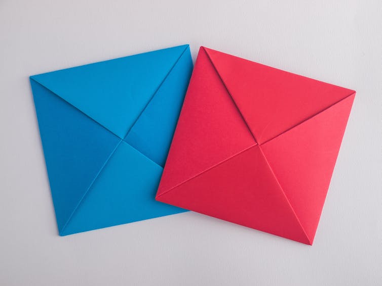Two folded paper squares, one red, one blue