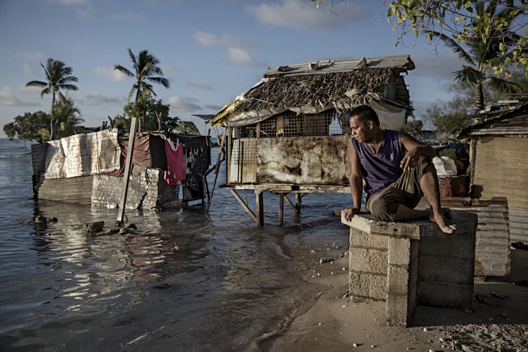 I-Kiribati man watching the sea enter his land