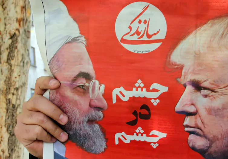 Iranian newspaper with photos of Rouhani and Trump.