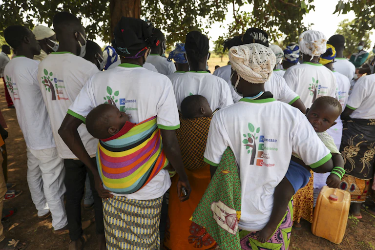 women holding babies standing around