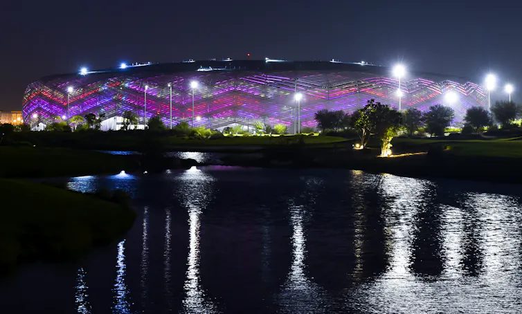 Illuminated stadium at night.