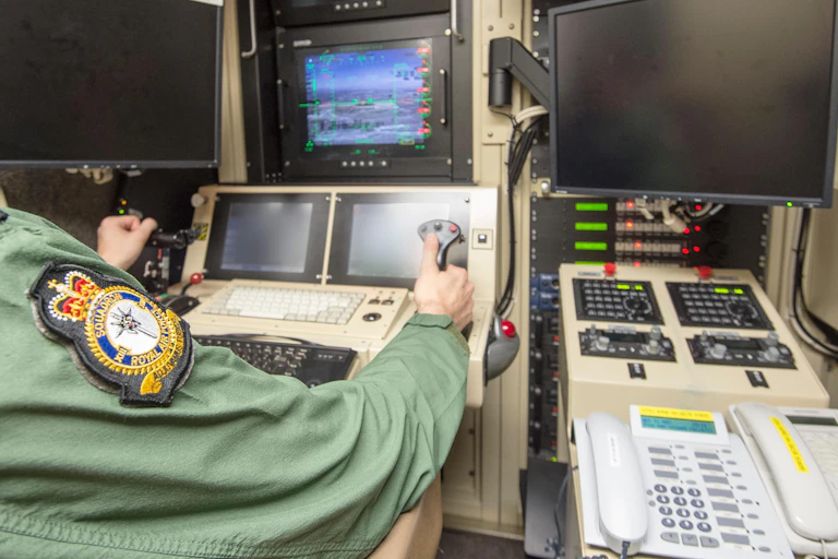 Pilots view in the high security Aircraft Hangar at RAF Waddington in Lincolnshire. Pilot controlling a Reaper drone in the Middle East and following on a monitor.