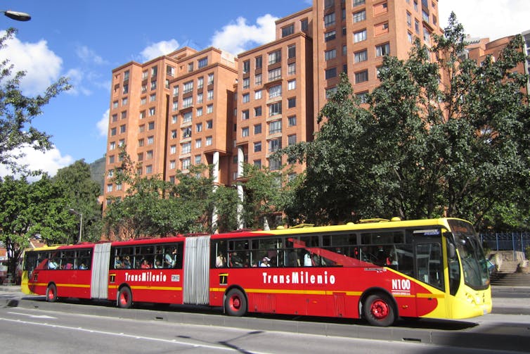 A red and yellow bus on a road