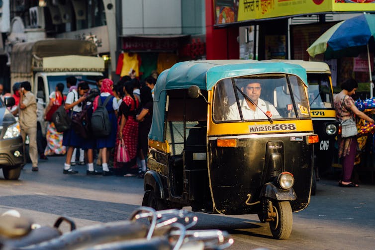 A person drives a rickshaw