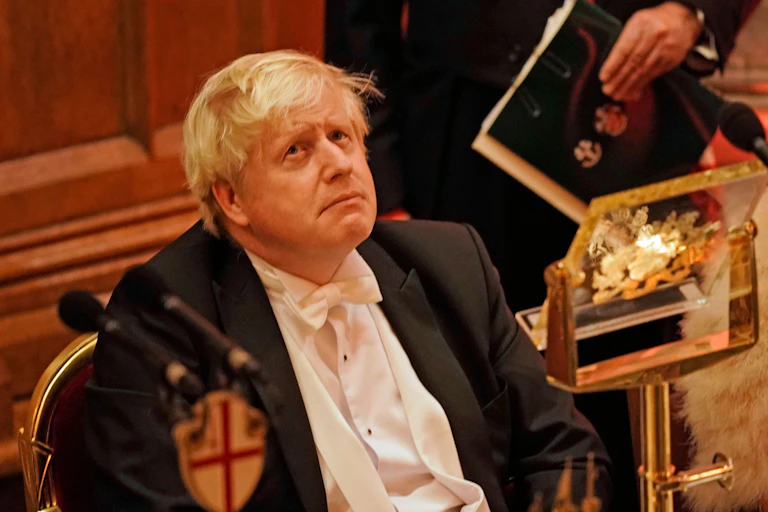 Boris Johnson wearing white tie at a dinner.