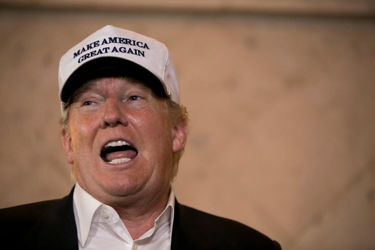 Donald Trump wearing MAGA cap.