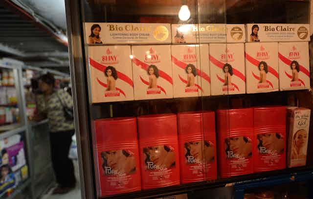 Shop display of products with light skinned women on the packaging and names like 'shiny' and 'pure skin'
