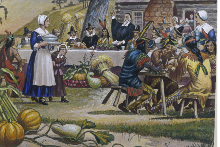 Pilgrims and Native Americans gather at tables to eat.