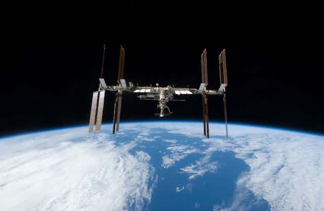 A space station with Earth and the horizon in the background. 