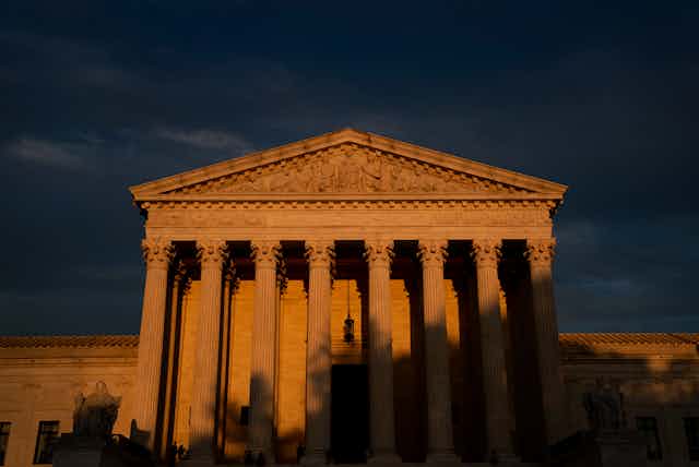 The front of the Supreme Court building, one-third in shadow.
