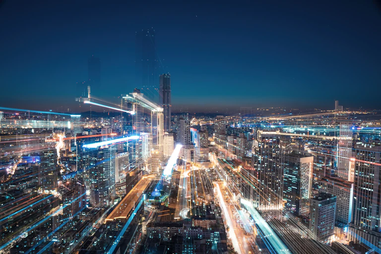 A city at dusk with lines of light superimposed