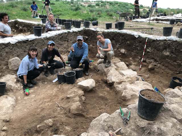 Volunteers and professor working on an archaelogical dig  at Khirbet el-Rai, Israel.