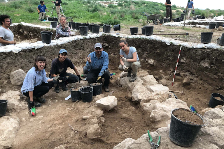 Volunteers and professor working on an archaelogical dig at Khirbet el-Rai, Israel.
