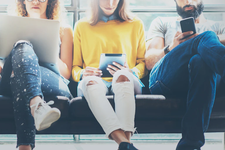 Young office workers with laptops and tablets.
