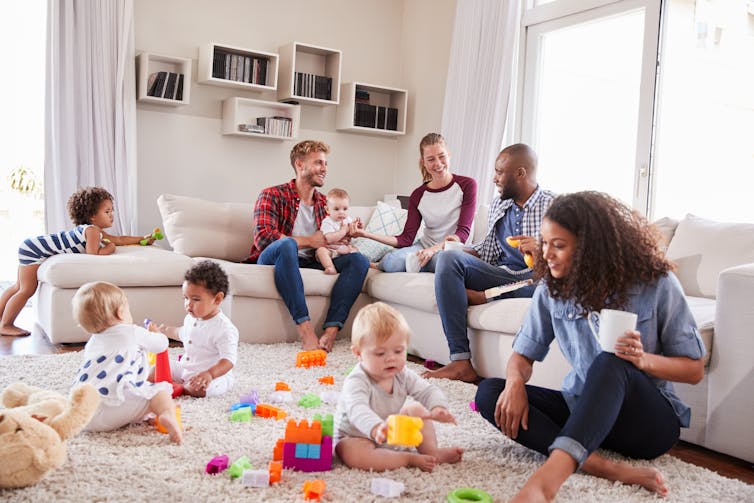 Two sets of parents and toddlers together on a play-date