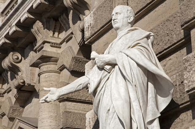A statue of Cicero in front of a building