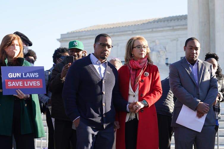 People gather at a gun-control action in front of the Supreme Court.