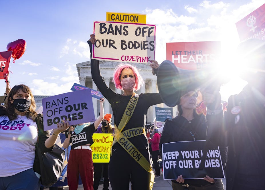 Women hold up 'bans off our bodies' signs outside US supreme court. 