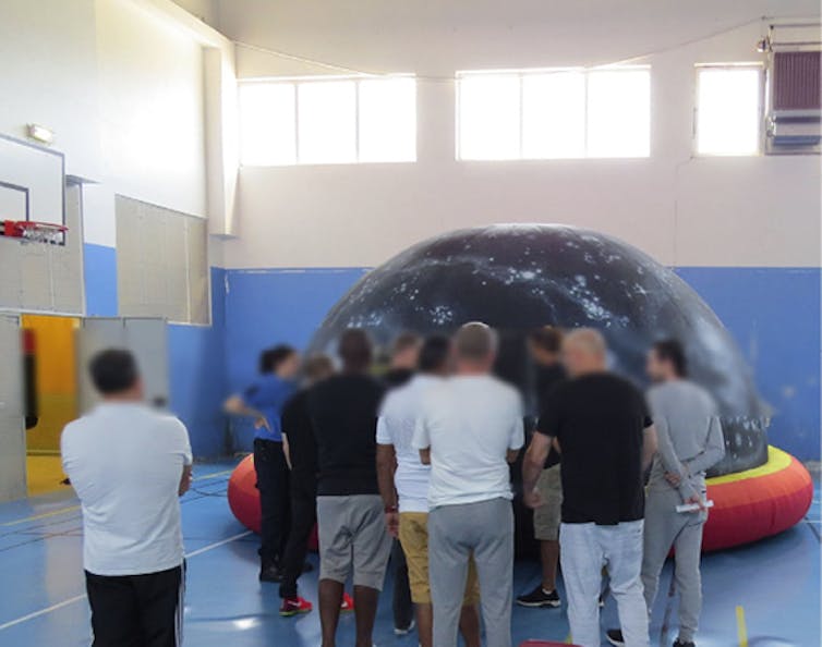 Des détenus du centre pénitentiaire de Liancourt devant un planetarium lors d’un atelier d’astronomie