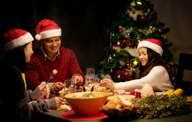 A family of three having Christmas dinner