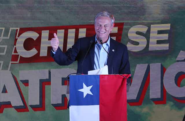 Chilean Republican Party candidate José Antonio Kast gives a thumbs up sign to supporters after hearing the result of the general election, November 21 2021. 