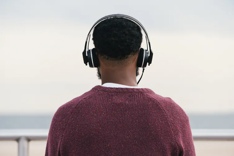 A man outside wearing headphones.
