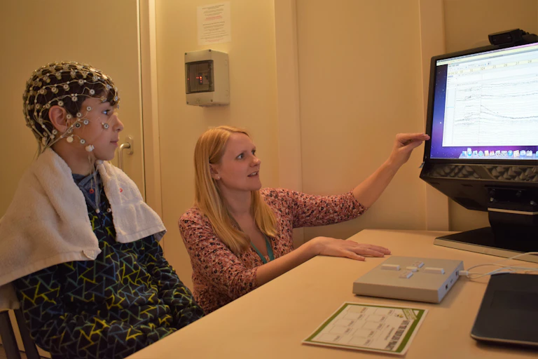 Boy wearing sensors on the head for an EEG brain activity test