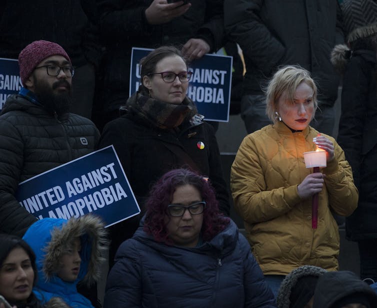 People are 'standing against Islamophobia' signs