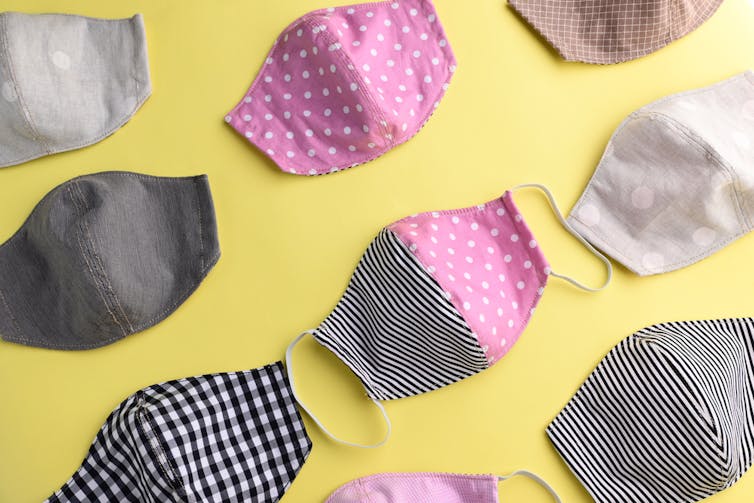 Cloth masks laid out on a yellow background